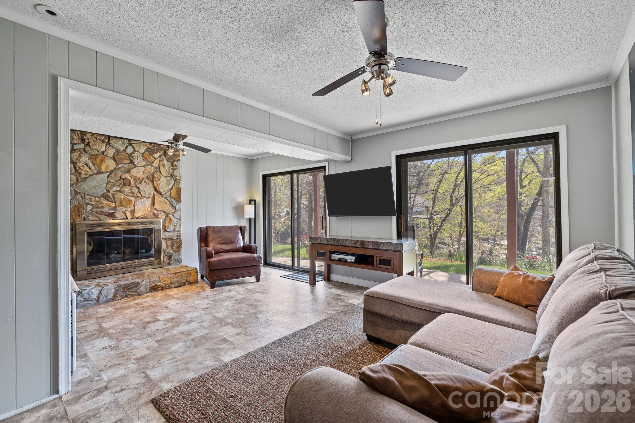 9067 Tulagi Court Fort Mill, SC 29708 - Photo 31 of 44 a living room with furniture large window and a flat screen tv