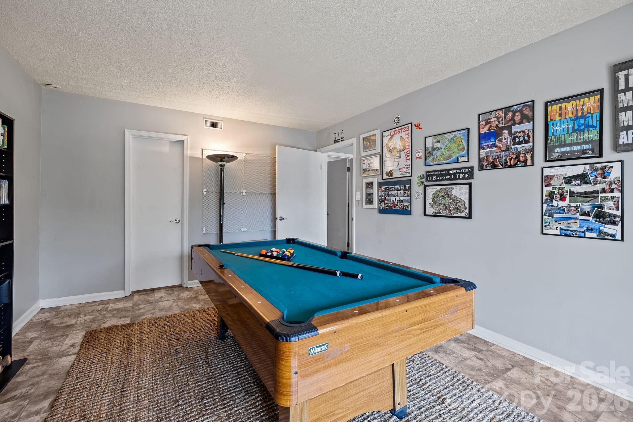 9067 Tulagi Court Fort Mill, SC 29708 - Photo 35 of 44 a room with pool table and paintings on the wall