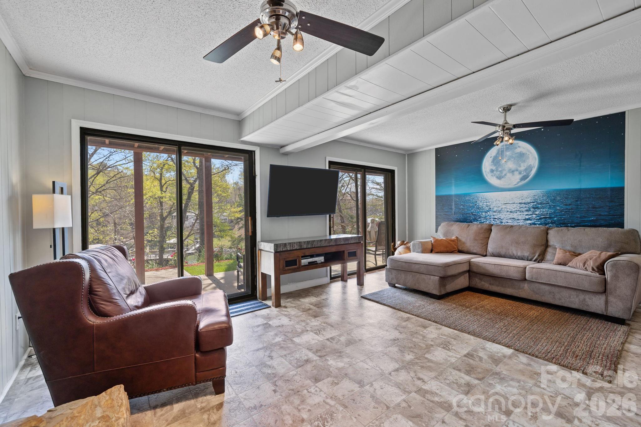 9067 Tulagi Court Fort Mill, SC 29708 - Photo 36 of 44 a living room with furniture ceiling fan and a large window