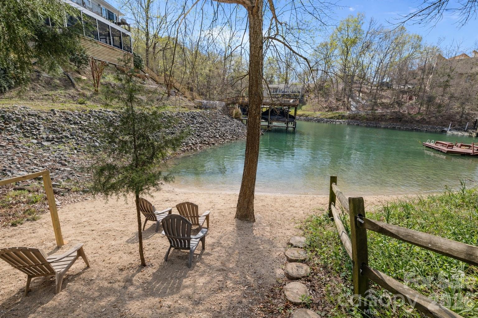 9067 Tulagi Court Fort Mill, SC 29708 - Photo 41 of 44 a view of a lake with a bench and trees