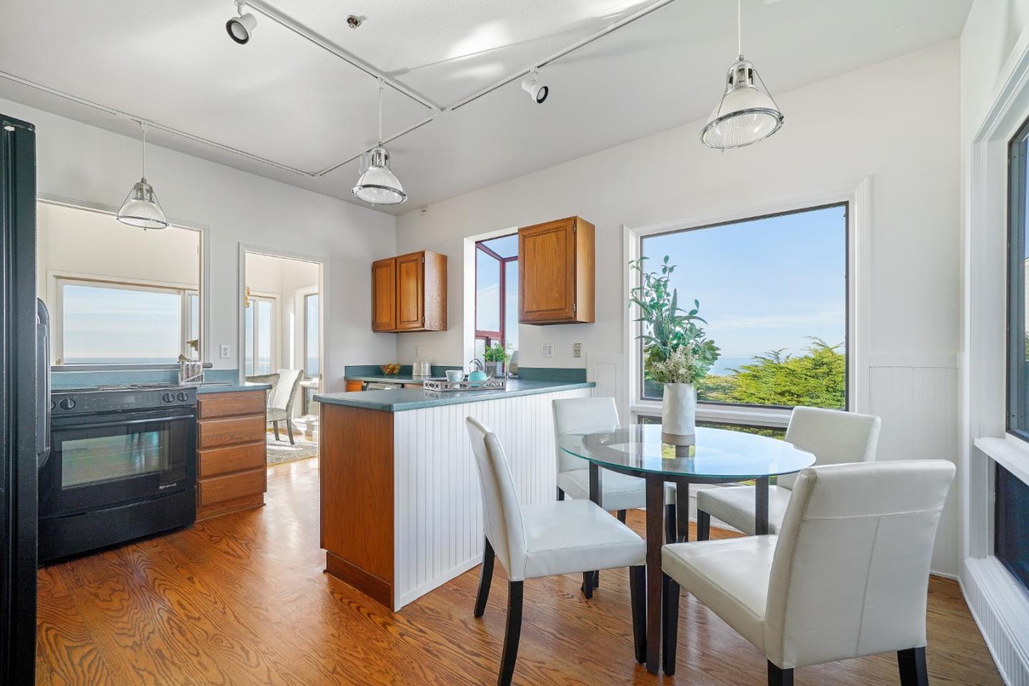 215 Roberts Road Pacifica, CA 94044 - Photo 12 of 40 a view of a dining room with furniture a kitchen and chandelier