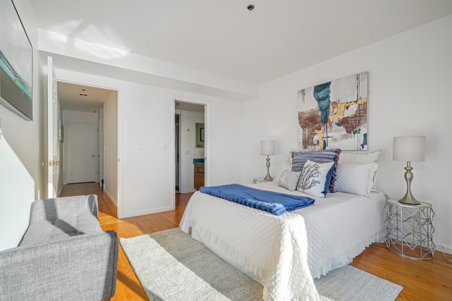 215 Roberts Road Pacifica, CA 94044 - Photo 22 of 40 a bedroom with a bed and wooden floor