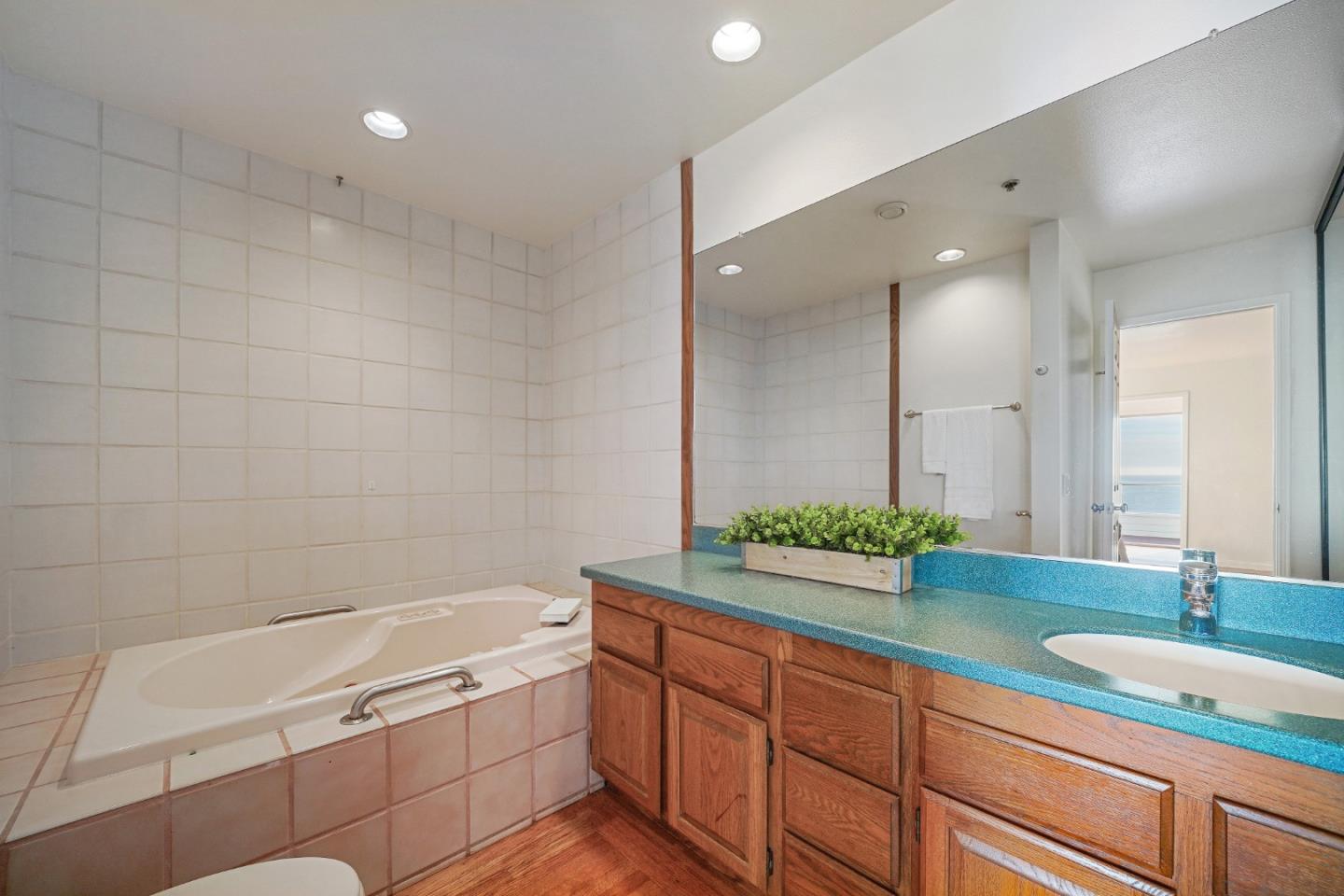 215 Roberts Road Pacifica, CA 94044 - Photo 24 of 40 a bathroom with a granite countertop sink mirror and bathtub