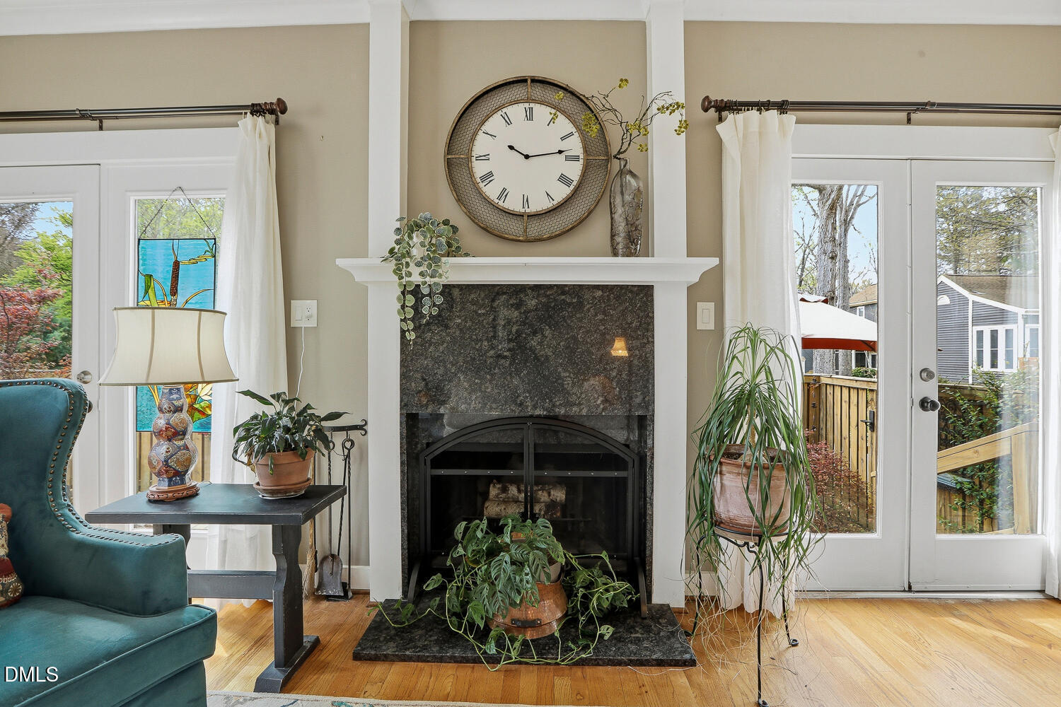 6023 Sentinel Drive Raleigh, NC 27609 - Photo 6 of 53 a living room with furniture a clock and a fireplace