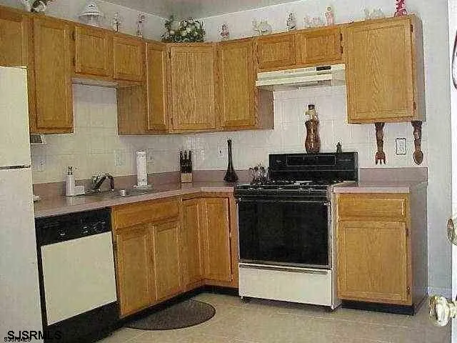 a kitchen with stainless steel appliances a stove a sink and a microwave