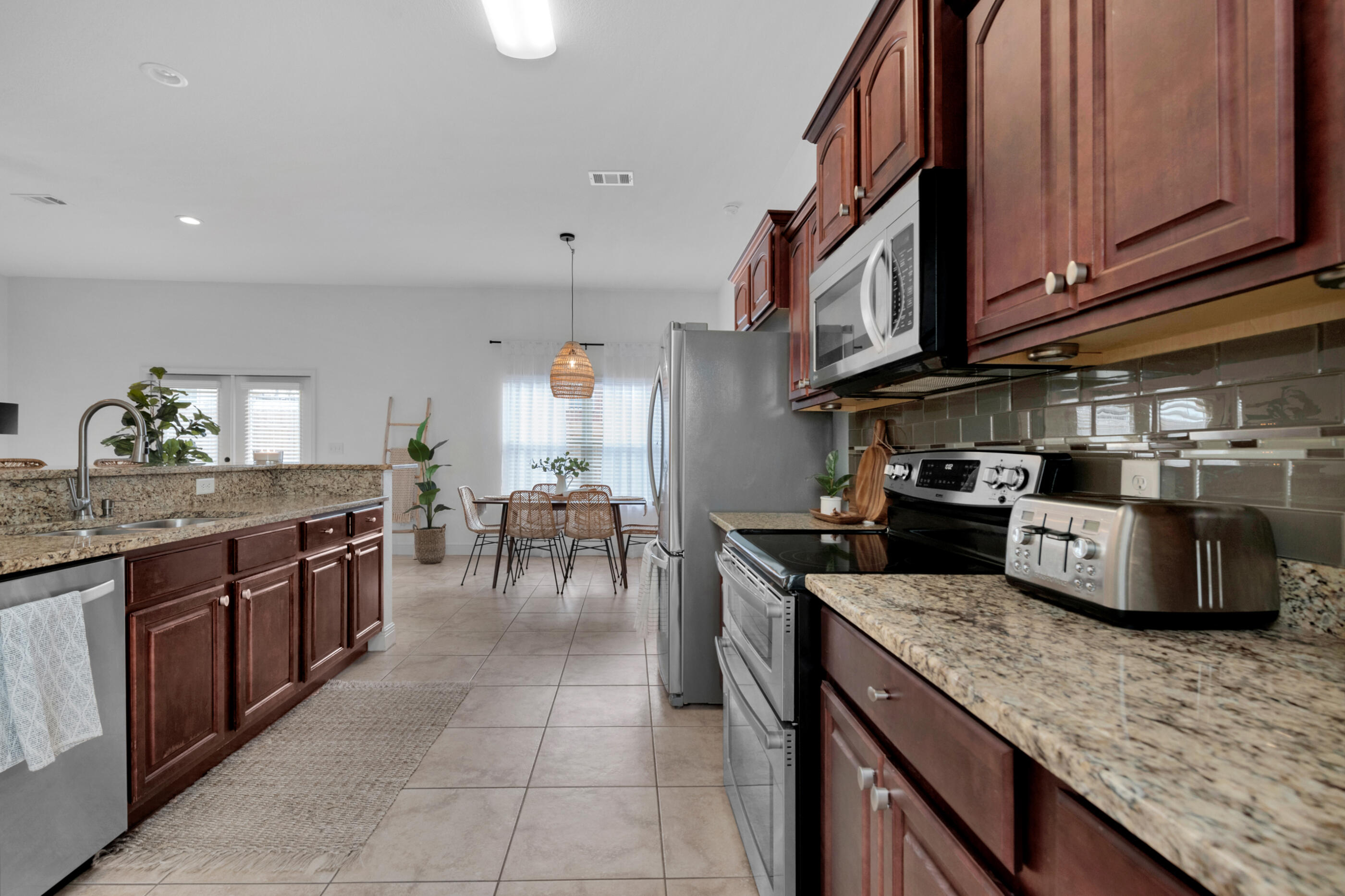 4567 Hermosa Road Crestview, FL 32539 - Photo 15 of 28 a kitchen with stainless steel appliances granite countertop a stove a sink and a microwave