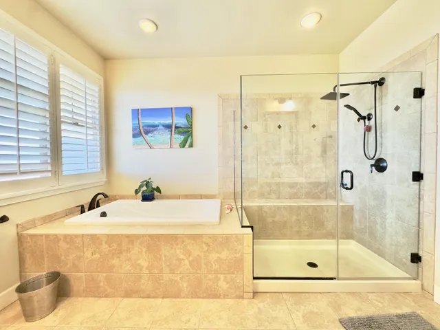 a bathroom with a tub sink and mirror