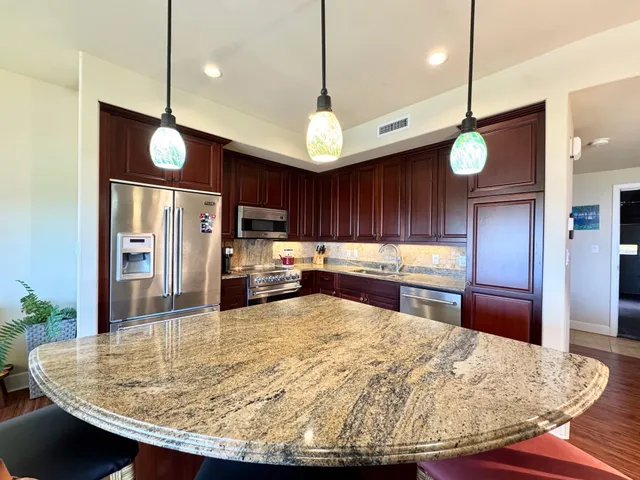 a kitchen with kitchen island a counter space and wooden floor
