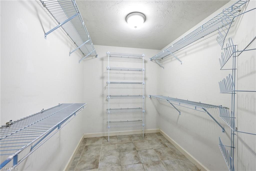 13105 Vanderbilt Drive, Unit 407 Naples, FL 34110 - Photo 26 of 38 Walk - In Closet