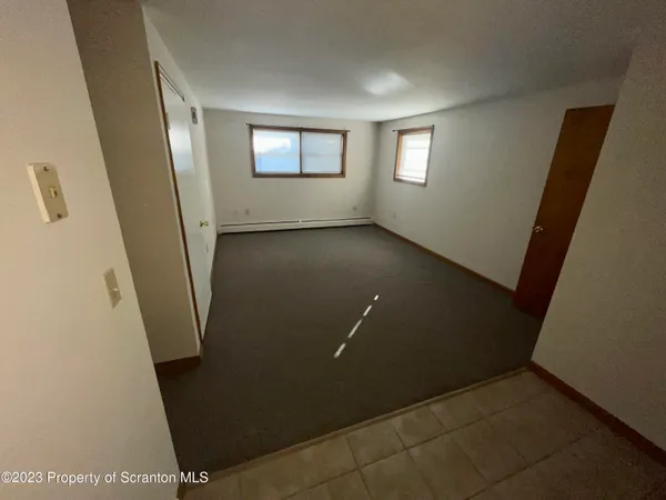 a view of a livingroom with an empty space and window
