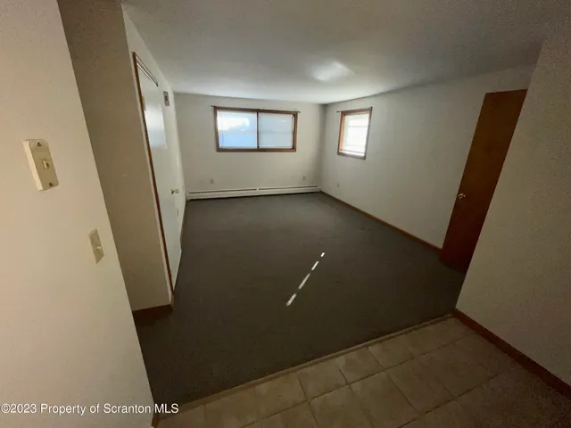 a view of a livingroom with an empty space and window
