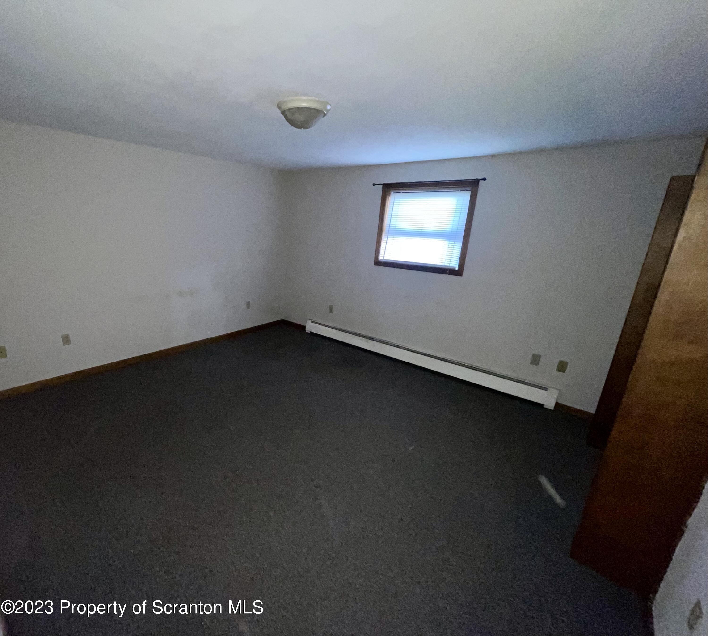 113 Frank Street, Unit 1 Dunmore, PA 18512 - Photo 6 of 9 an empty room with a window