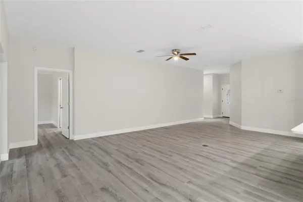 a view of a room with wooden floor