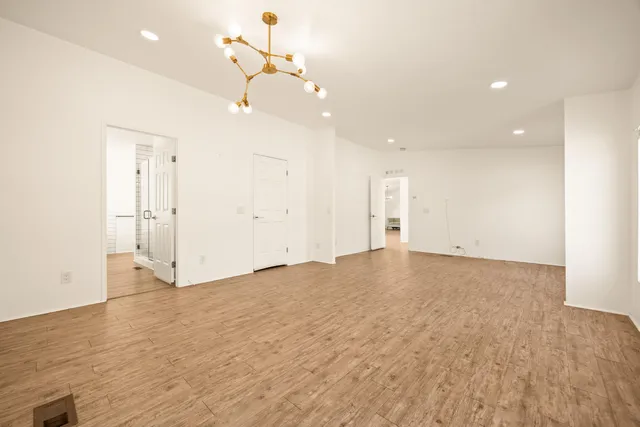 a spacious bathroom with a double vanity sink a mirror and a bathtub