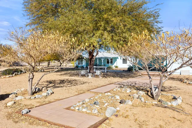 a view of a house with backyard porch and sitting area