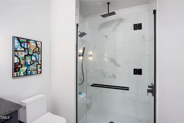 a vase of flowers sitting on a table in a bedroom