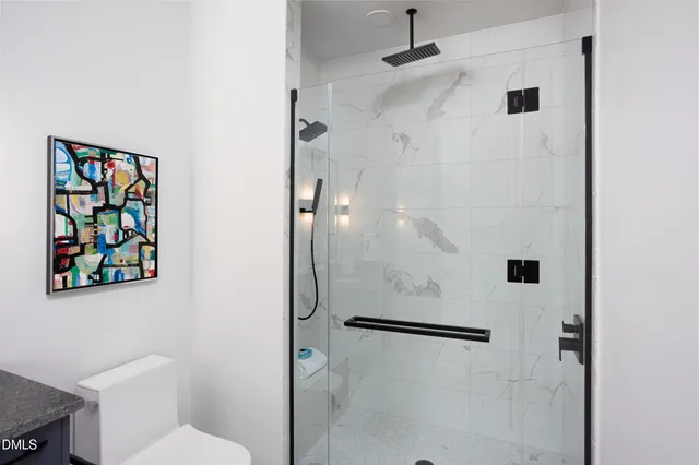 a vase of flowers sitting on a table in a bedroom