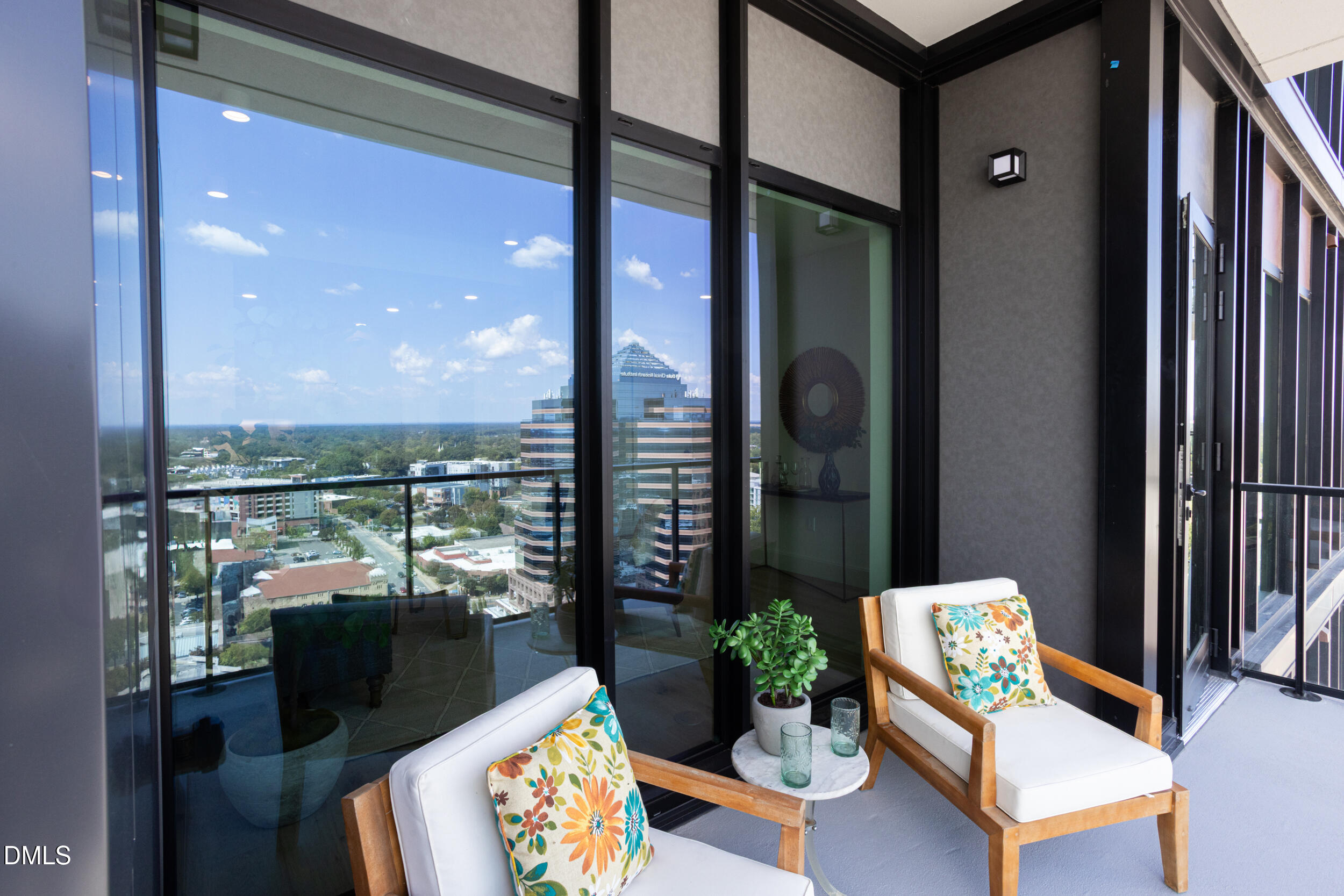 115 Morris Street, Unit 1903 Durham, NC 27701 - Photo 29 of 68 a balcony with furniture and a potted plant