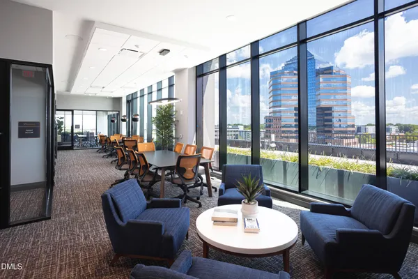 a large kitchen with kitchen island a large window in it