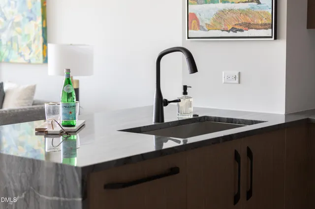 a living room with stainless steel appliances kitchen island furniture and a kitchen view