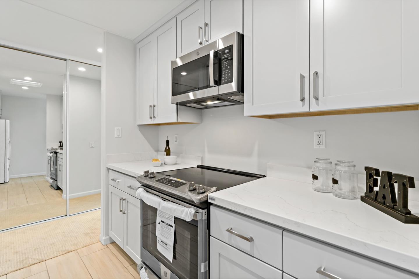 340 Vallejo Drive, Unit 53 Millbrae, CA 94030 - Photo 23 of 50 a kitchen with stainless steel appliances white cabinets and a stove