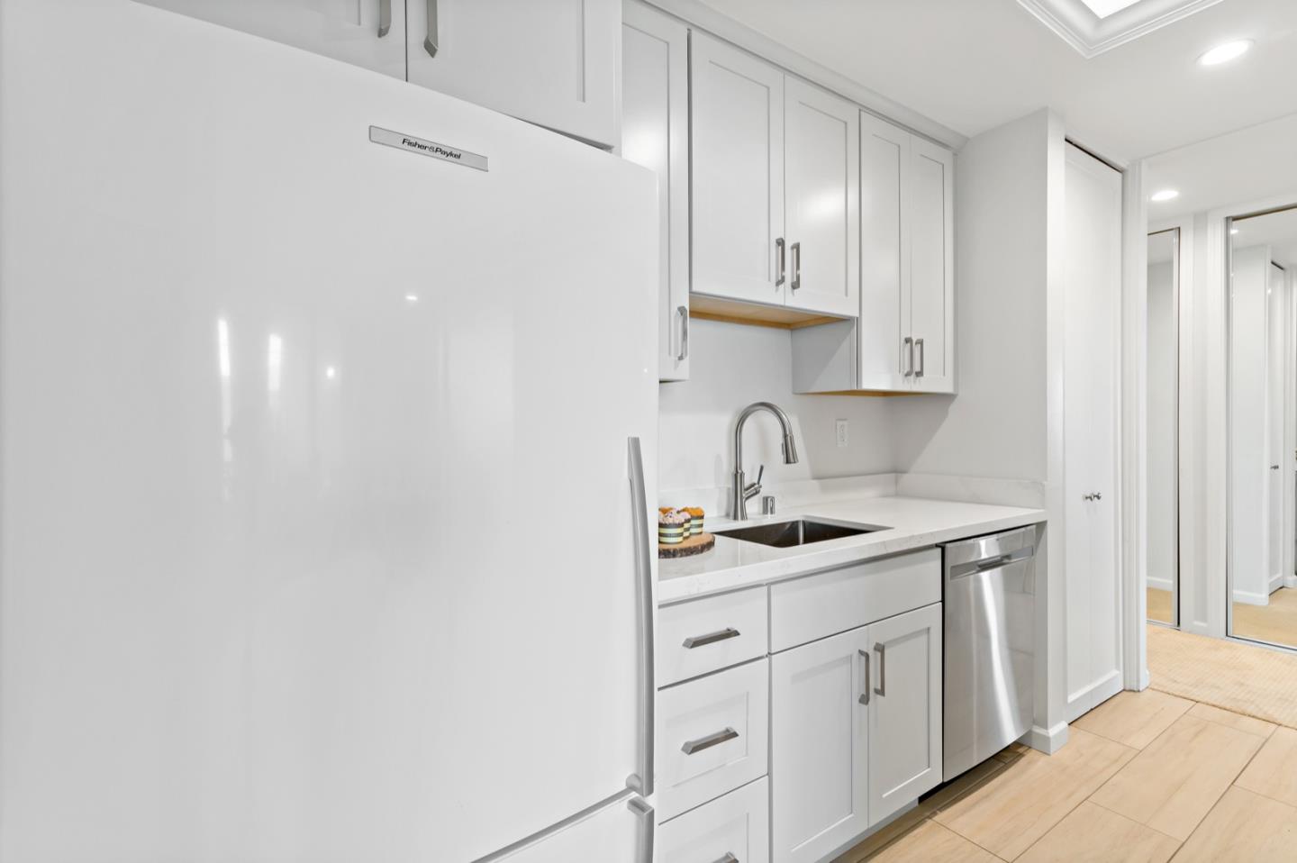 340 Vallejo Drive, Unit 53 Millbrae, CA 94030 - Photo 25 of 50 a kitchen with white cabinets a sink and dishwasher