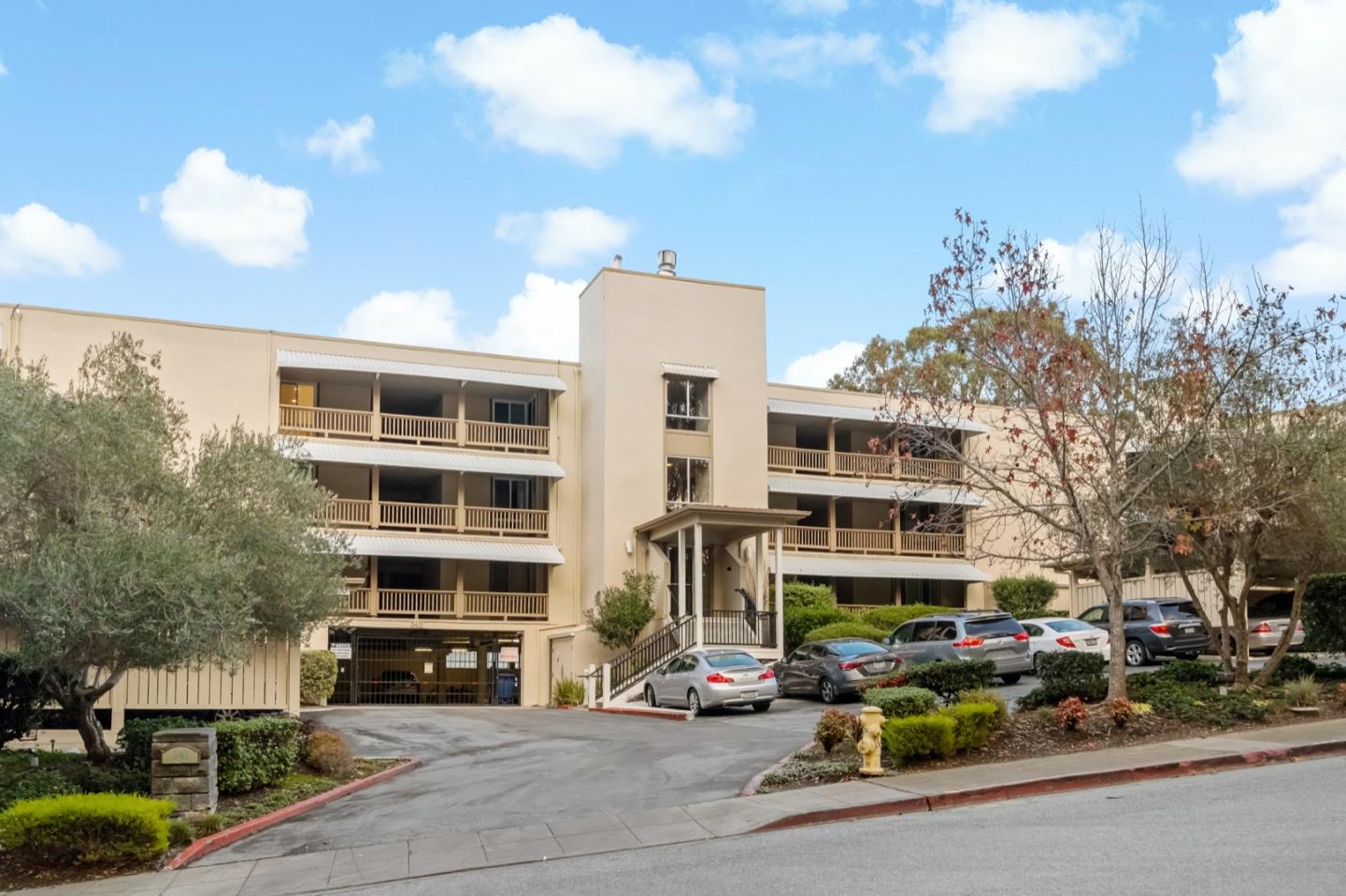 340 Vallejo Drive, Unit 53 Millbrae, CA 94030 - Photo 48 of 50 a front view of a building with lot of cars and trees