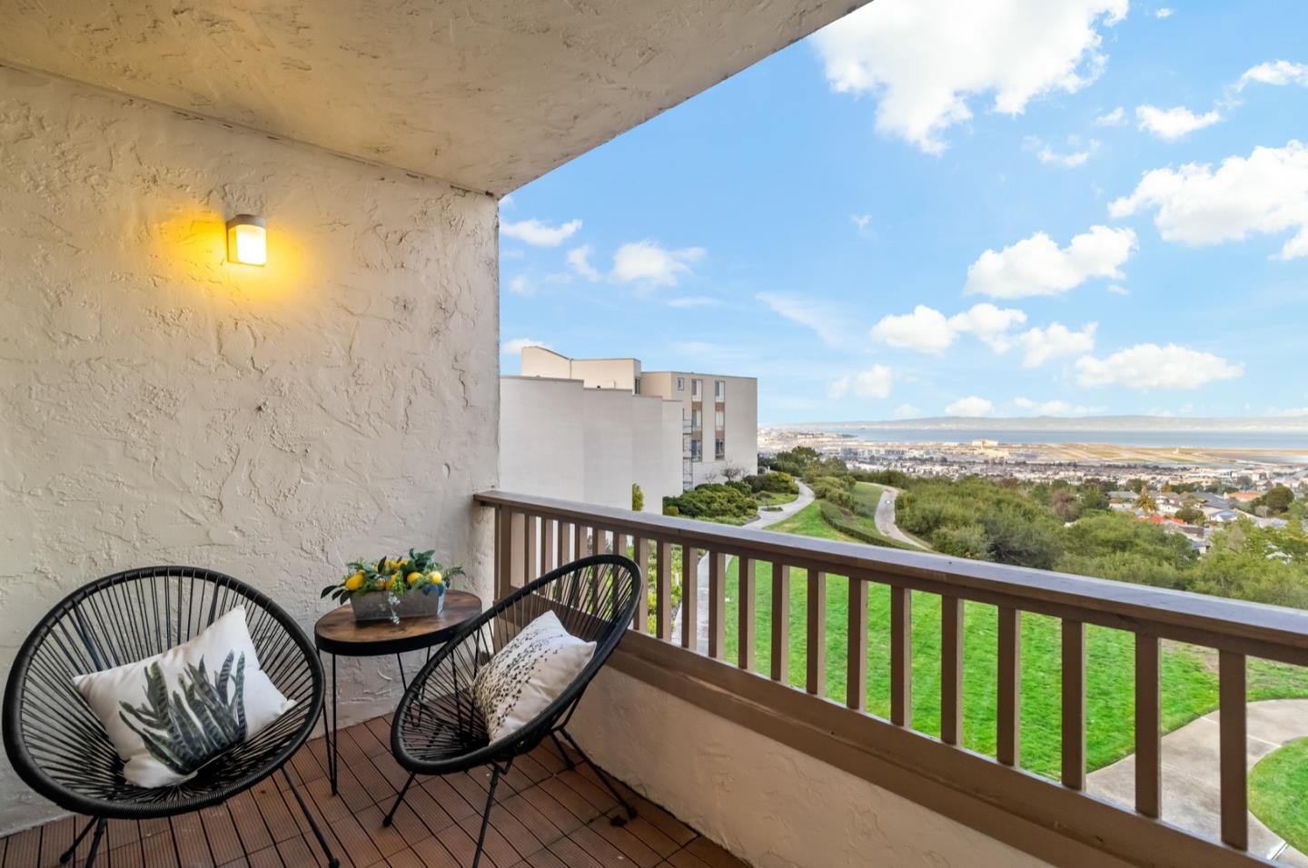 340 Vallejo Drive, Unit 53 Millbrae, CA 94030 - Photo 6 of 50 a view of a balcony with two chairs and a potted plant