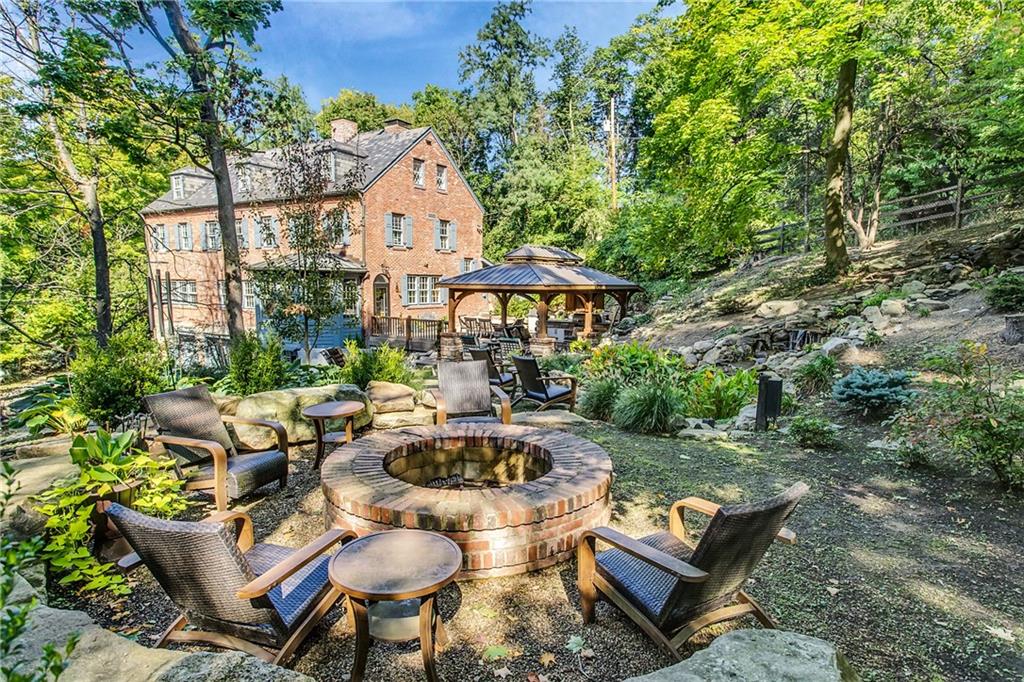 95 Woodland Road Pittsburgh, PA 15232 - Photo 20 of 25 The sellers of 95 East Woodland Road created this incredible outdoor entertainment and relaxation space 5 years ago. The one acre lot was professionally excavated and outfitted with many fabulous features, such as the electronic ignition gas firepit, the waterfall and koi pond area, hot tub, and the wonderful Amish crafted outdoor pavilion, which houses an outdoor grill/kitchen area, complete with overhead lighted ceiling fans and a mounted flat screen TV! You will feel like you are on vacation!