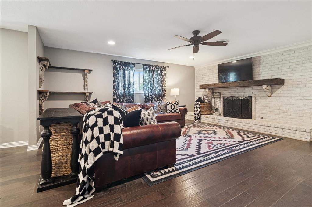 312 Old Justin Road Argyle, TX 76226 - Photo 6 of 24 a living room with furniture a flat screen tv and a fireplace
