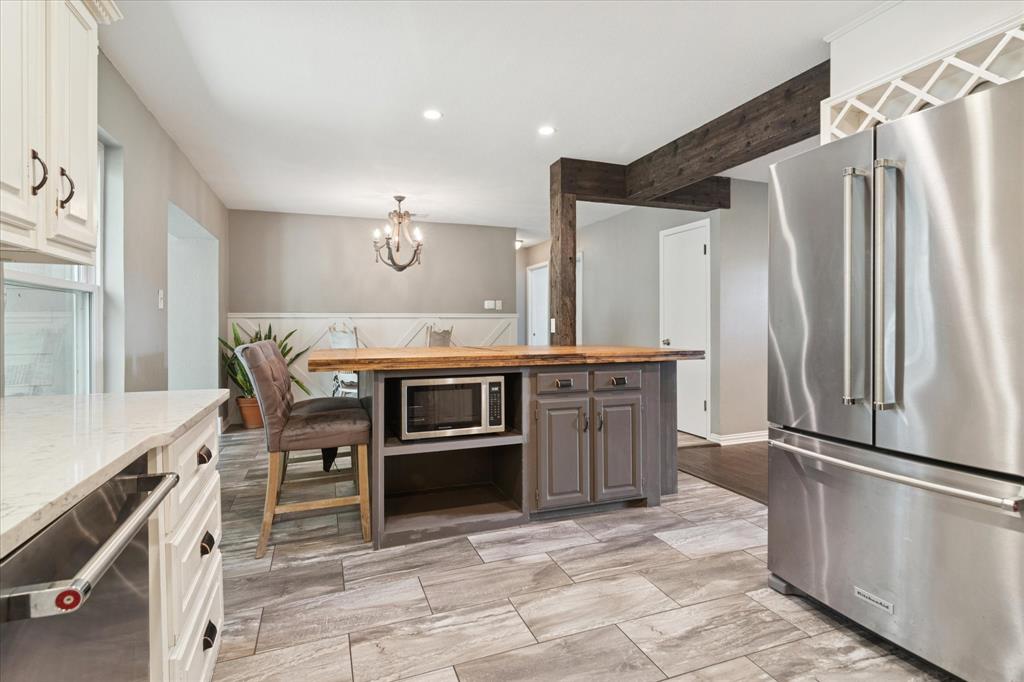 312 Old Justin Road Argyle, TX 76226 - Photo 10 of 24 a kitchen with stainless steel appliances a stove a refrigerator and a refrigerator