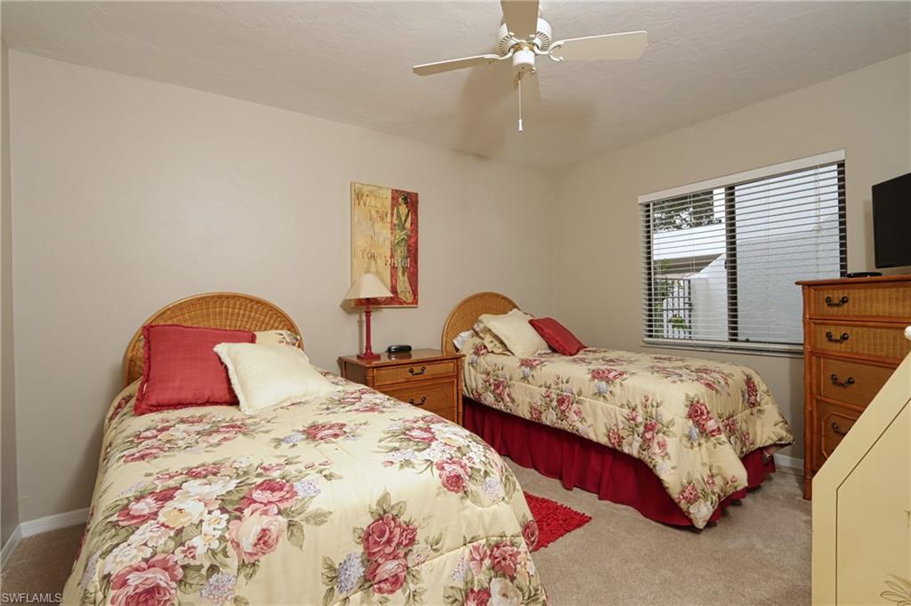 661 Windsurf Lane, Unit A103 Naples, FL 34108 - Photo 14 of 18 a bedroom with two beds and a window