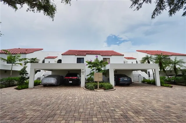 a bed sitting in a bedroom next to a lamp