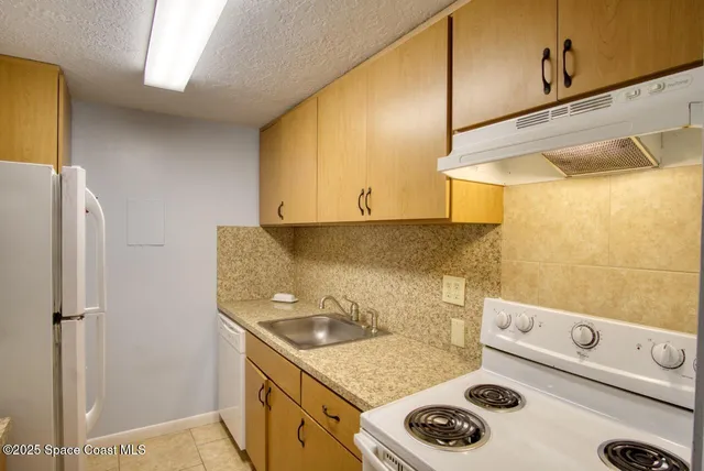 a utility room with sink dryer and washer