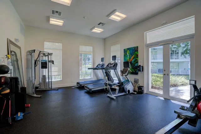 a view of a tennis ground with large trees