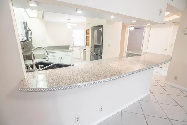 a kitchen with a sink and a refrigerator