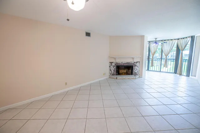 a view of an empty room with a fireplace