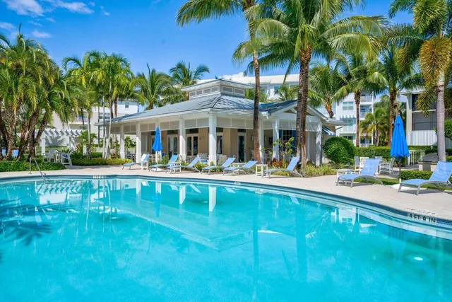 a view of house with swimming pool and a garden