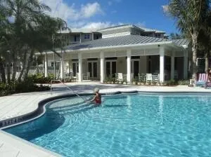 a view of a house with a swimming pool and porch