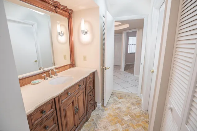 a bathroom with a sink a vanity and a mirror