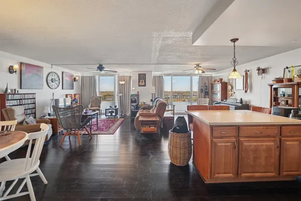 a living room with lots of furniture and kitchen view