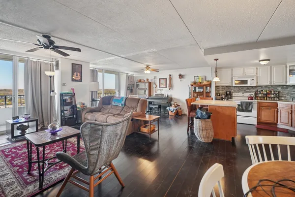 a living room with lots of furniture and kitchen view