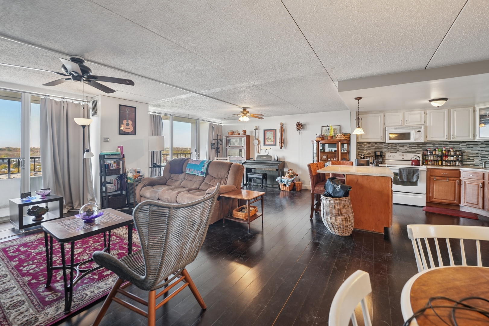 2005 South Finley Road, Unit 1202 Lombard, IL 60148 - Photo 17 of 29 a living room with lots of furniture and kitchen view