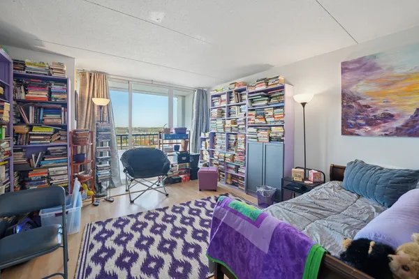 a bedroom with furniture and a book shelf
