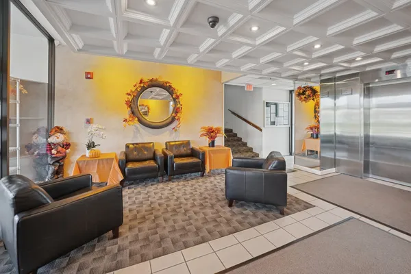 a living room with furniture and a clock