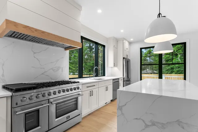 a kitchen with stainless steel appliances a stove a sink and a refrigerator