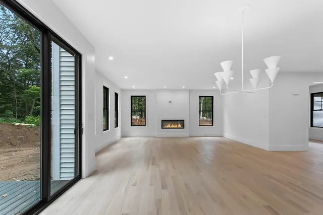 a view of a kitchen with wooden floor and window