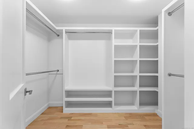 a view of walk in closet with empty racks