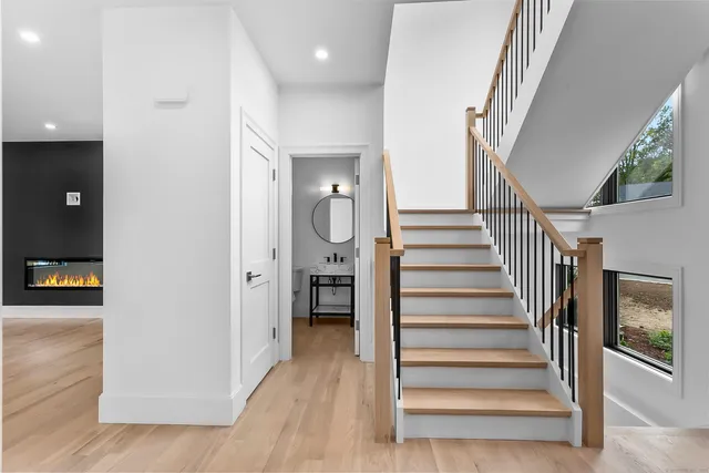 a view of entryway and hall with wooden floor