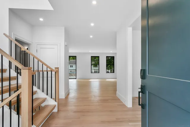 a view of an entryway with wooden floor